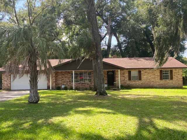 ranch-style home with a garage and a front lawn