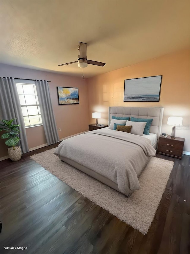 bedroom with ceiling fan and dark hardwood / wood-style floors