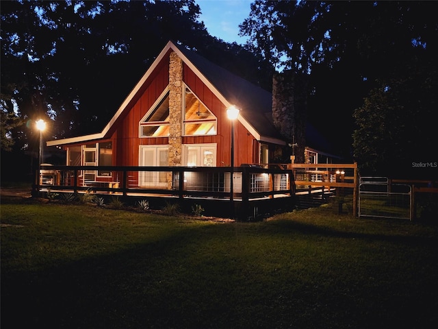 rear view of property with a yard