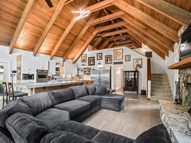 living room featuring beamed ceiling, light hardwood / wood-style floors, high vaulted ceiling, and wood ceiling