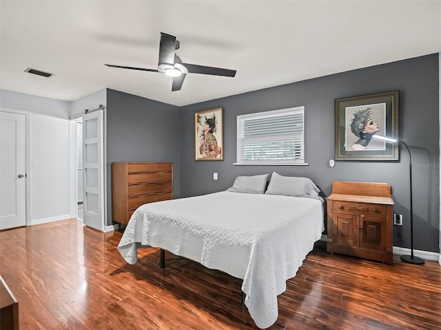 bedroom featuring ceiling fan and dark hardwood / wood-style flooring