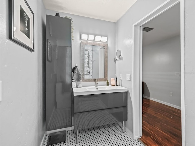 bathroom with vanity and hardwood / wood-style flooring