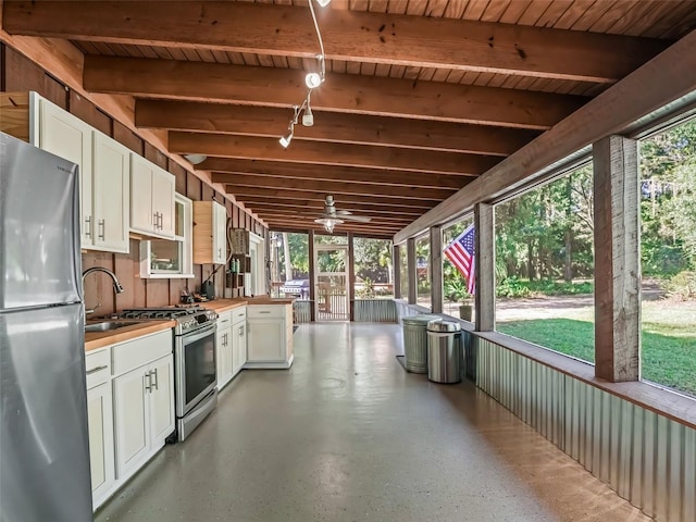 interior space featuring area for grilling, ceiling fan, and sink