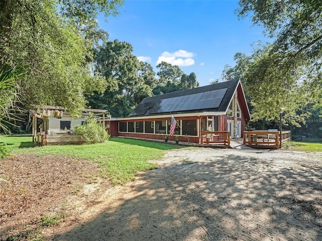 view of front of home with solar panels and a deck