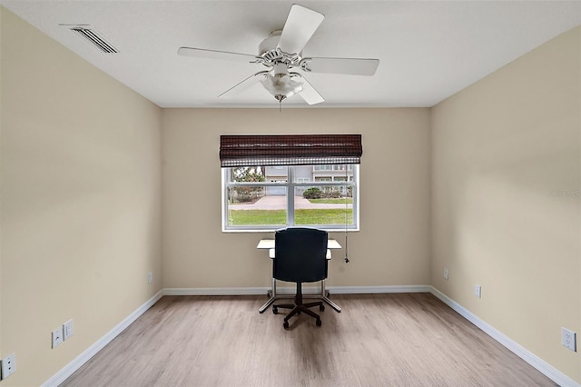 unfurnished office with a ceiling fan, baseboards, visible vents, and light wood finished floors