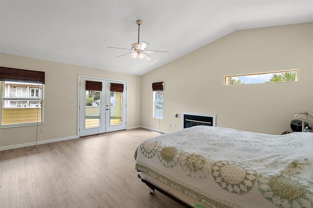 bedroom featuring light wood-type flooring, vaulted ceiling, access to outside, and ceiling fan