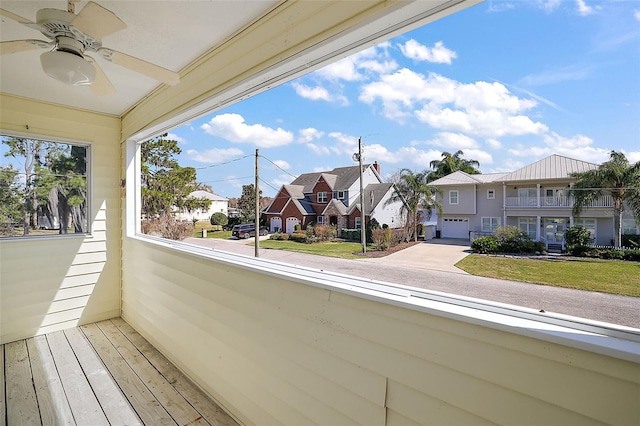 balcony featuring ceiling fan and a residential view