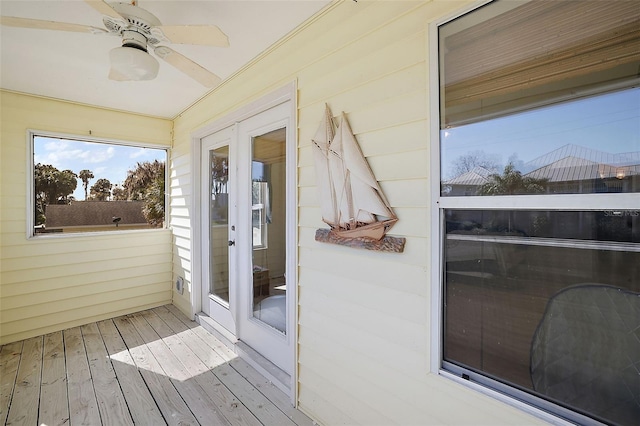 sunroom featuring a ceiling fan and french doors