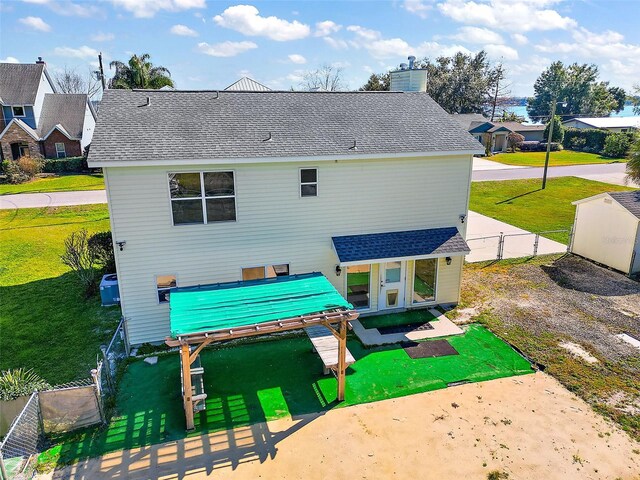 back of property featuring a lawn