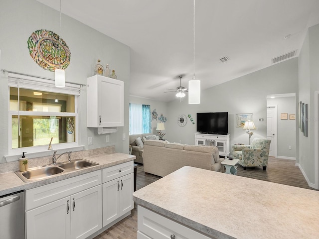 kitchen featuring dishwasher, ceiling fan, sink, and wood-type flooring