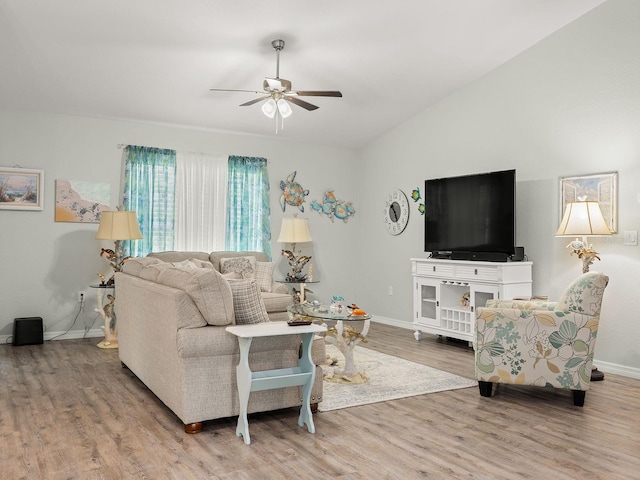 living room featuring ceiling fan, hardwood / wood-style flooring, and vaulted ceiling