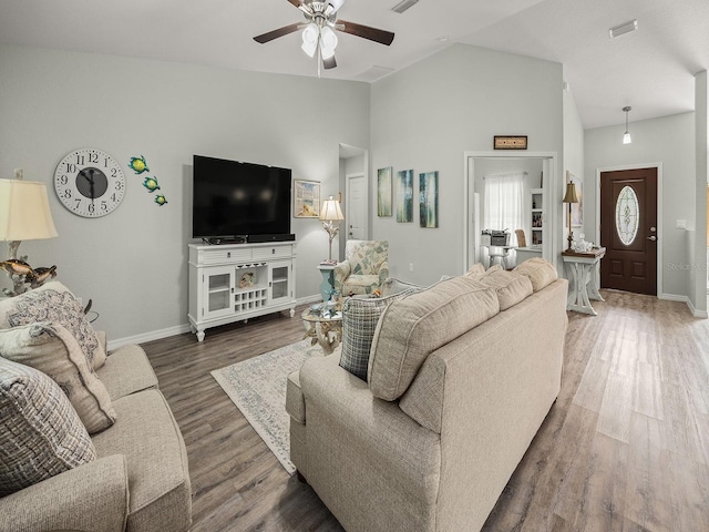 living room featuring dark wood-type flooring, ceiling fan, and high vaulted ceiling