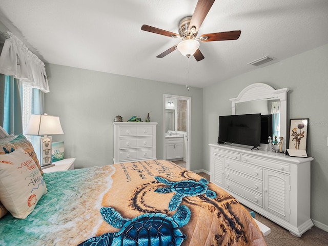 carpeted bedroom with ceiling fan and connected bathroom