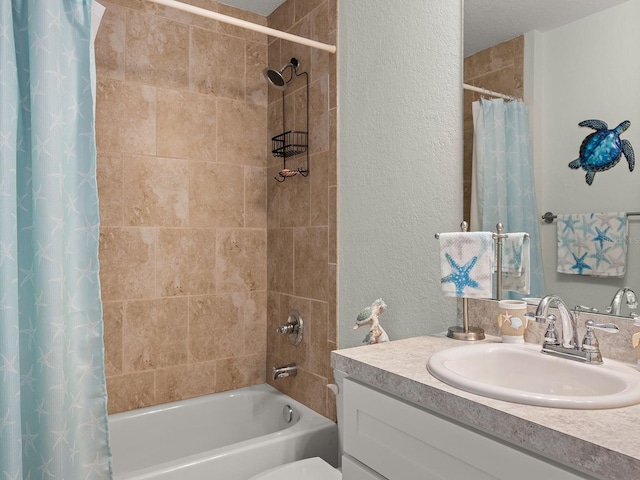 bathroom with vanity, a textured ceiling, and shower / bath combo with shower curtain