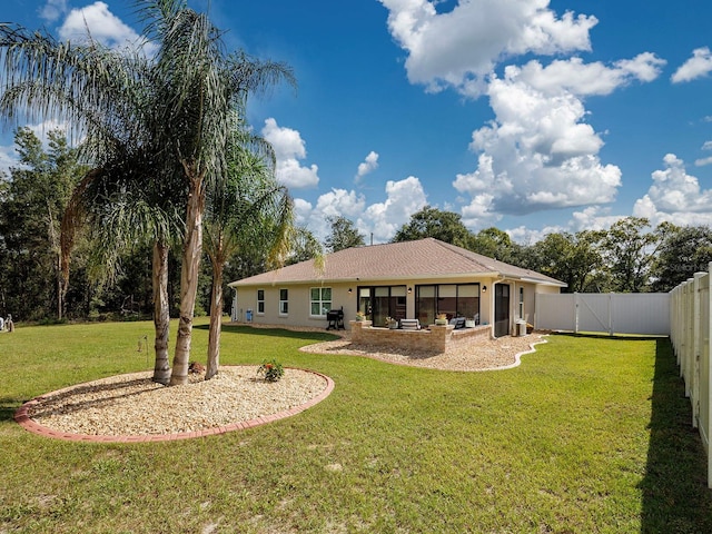 back of house with a patio area and a yard