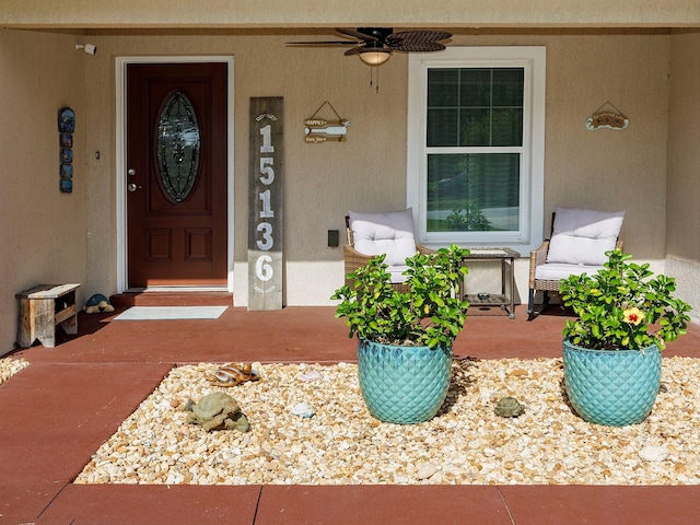 entrance to property featuring ceiling fan