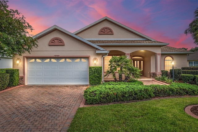 view of front facade featuring a yard and a garage