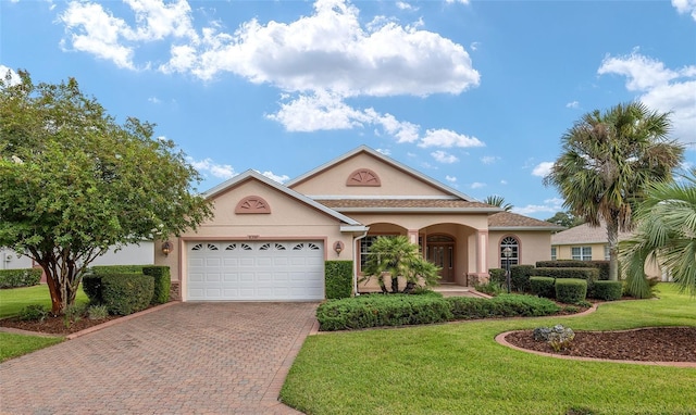 view of front of house with a front yard and a garage