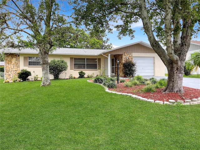 ranch-style home with a garage and a front lawn