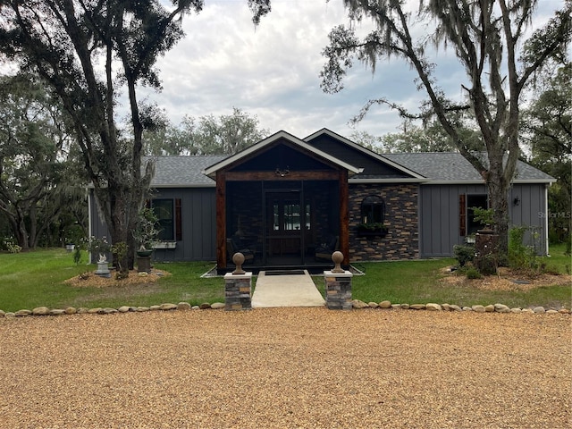 single story home with french doors and a front yard