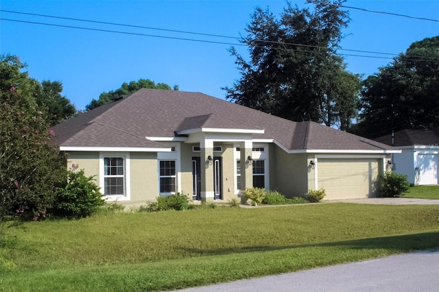 view of front of house featuring a front yard and a garage