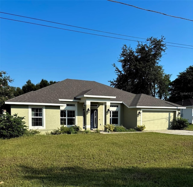 single story home featuring a garage and a front lawn