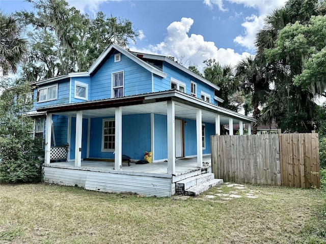 view of front of home with a porch and a front lawn