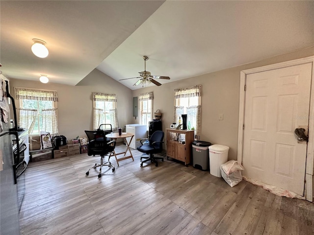 office with ceiling fan, electric panel, vaulted ceiling, and light hardwood / wood-style flooring