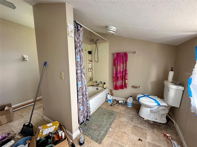 bathroom featuring tile patterned floors, a textured ceiling, shower / tub combo with curtain, and toilet