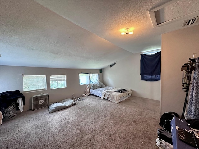 bedroom featuring a textured ceiling, carpet floors, and lofted ceiling