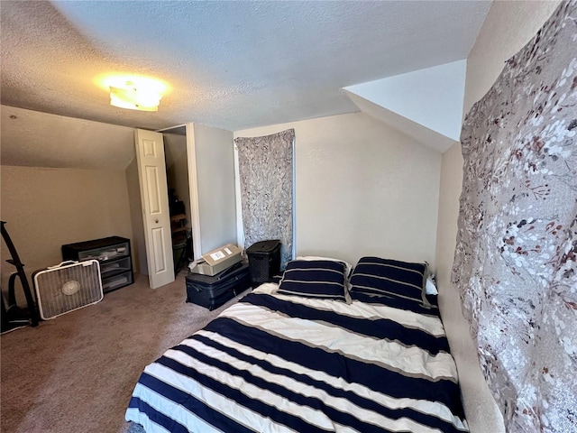 carpeted bedroom with vaulted ceiling and a textured ceiling