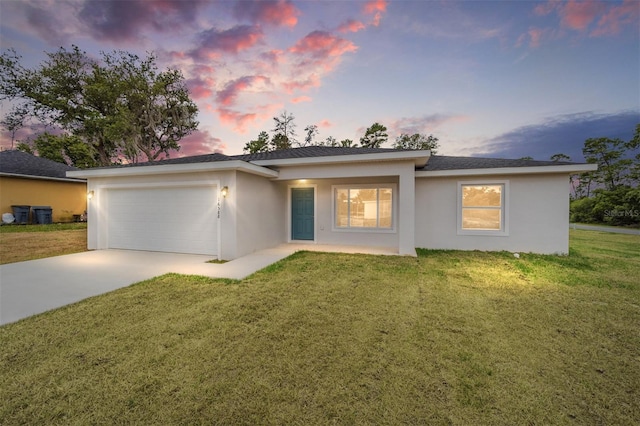 view of front of property with a lawn and a garage