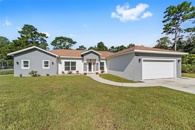 ranch-style house with a garage and a front lawn