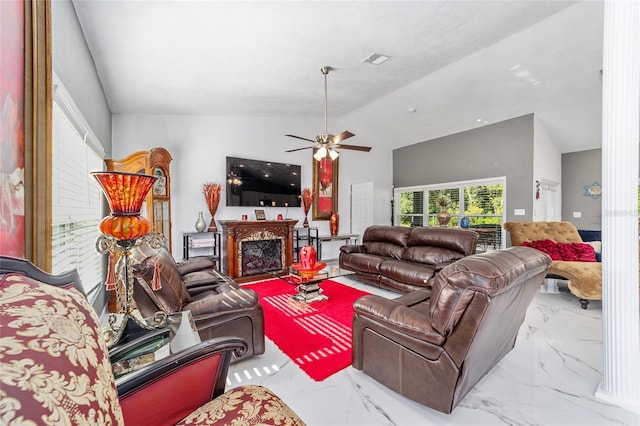 living area with lofted ceiling, marble finish floor, a fireplace, and visible vents