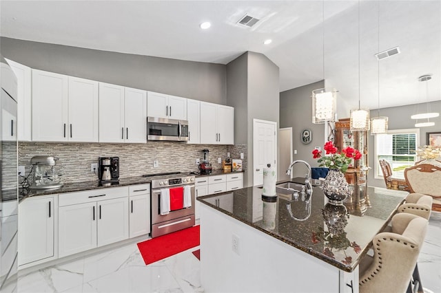 kitchen featuring visible vents, marble finish floor, vaulted ceiling, stainless steel appliances, and a sink