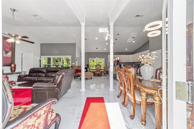 living area with marble finish floor, ceiling fan, visible vents, and high vaulted ceiling