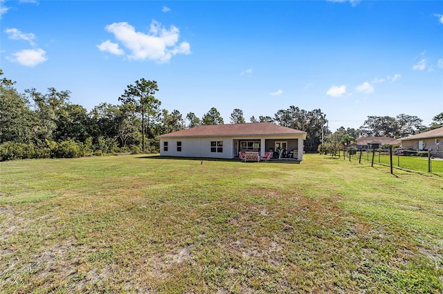 exterior space featuring fence and a front lawn