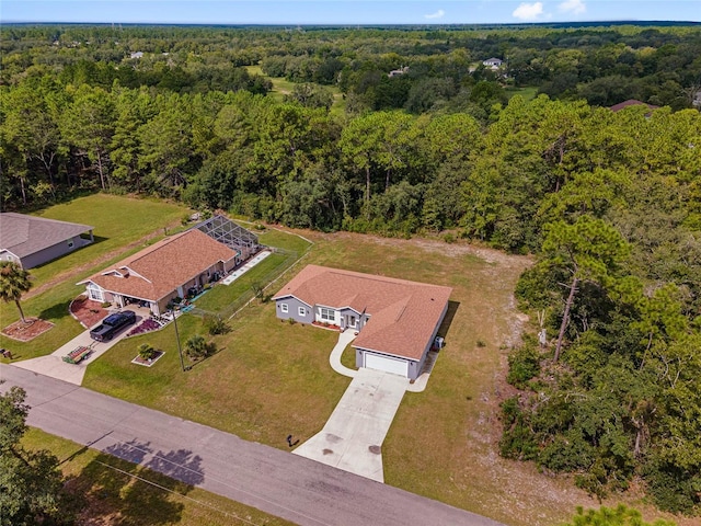 drone / aerial view with a wooded view