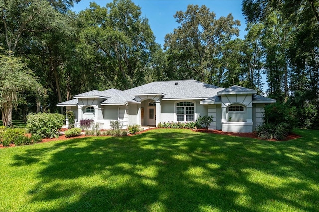 view of front of home featuring a front lawn and stucco siding