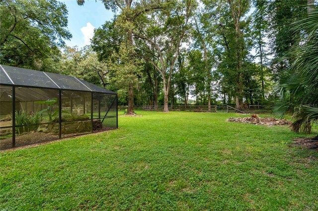 view of yard with glass enclosure