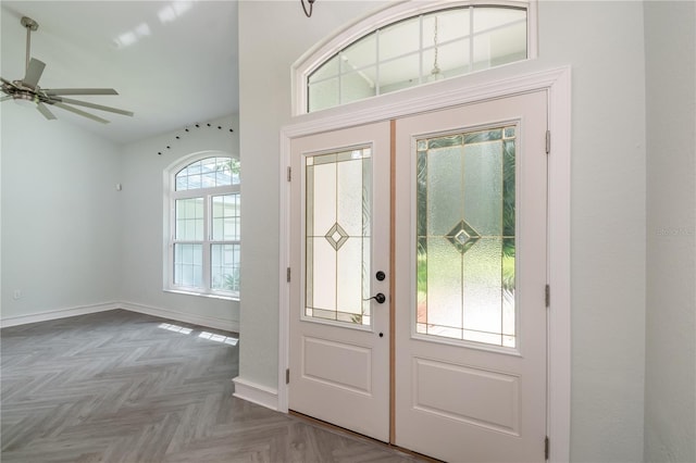 foyer entrance with french doors, parquet flooring, and ceiling fan