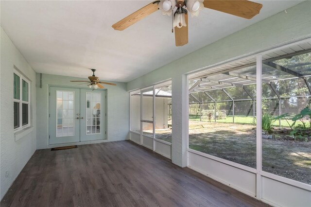 unfurnished sunroom featuring french doors, a healthy amount of sunlight, and ceiling fan