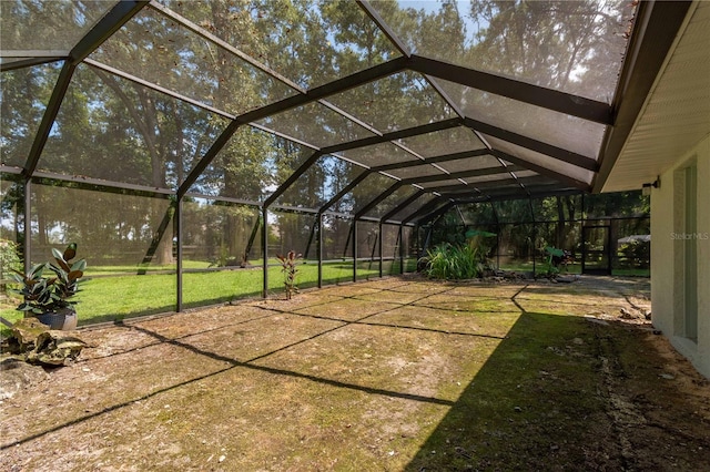 view of yard featuring glass enclosure and a patio area