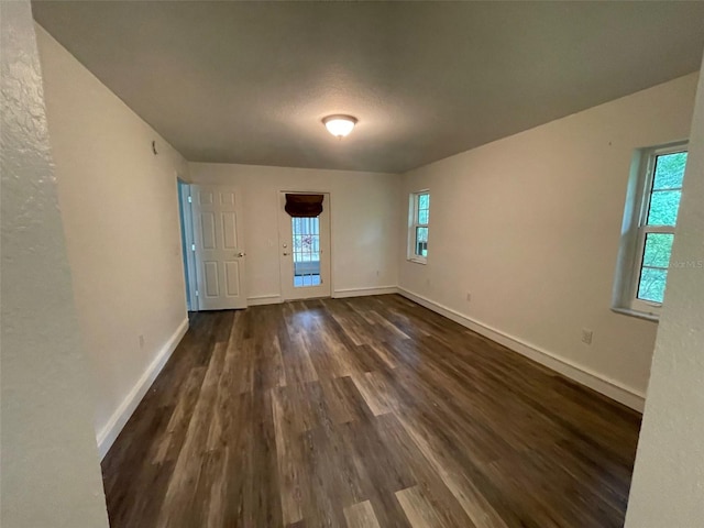 unfurnished room featuring dark hardwood / wood-style flooring