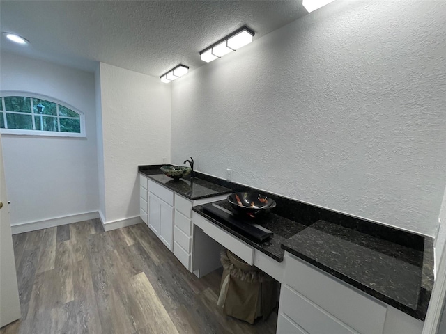 bathroom featuring a textured ceiling, sink, and hardwood / wood-style flooring