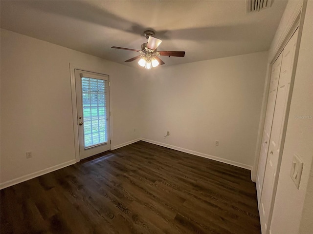 unfurnished bedroom with dark hardwood / wood-style flooring and ceiling fan