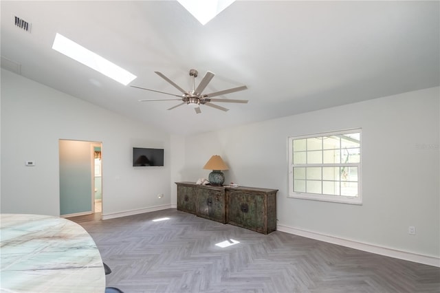 bedroom with ceiling fan, vaulted ceiling with skylight, parquet flooring, and ensuite bathroom