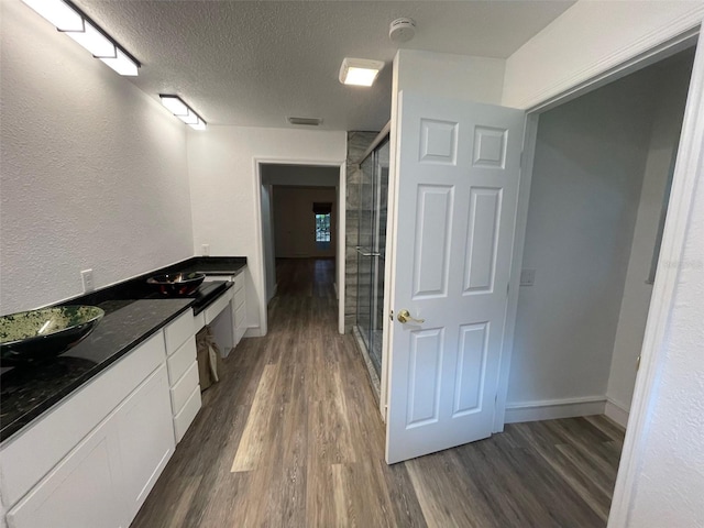 interior space featuring dark hardwood / wood-style floors and a textured ceiling