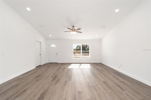 unfurnished living room with hardwood / wood-style flooring and ceiling fan