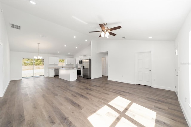 unfurnished living room featuring ceiling fan with notable chandelier, high vaulted ceiling, and light hardwood / wood-style flooring